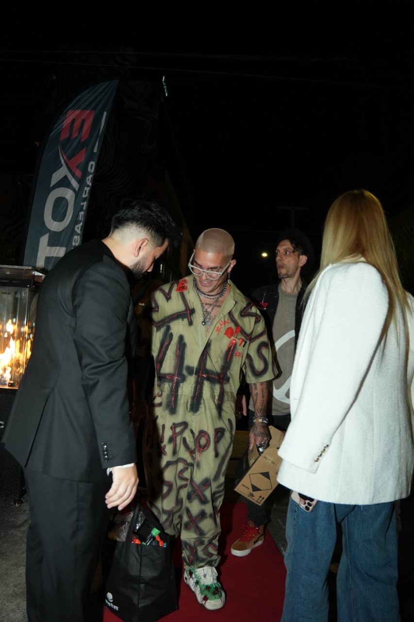 Guest in a graffiti jumpsuit arriving on the red carpet at the SORA Event